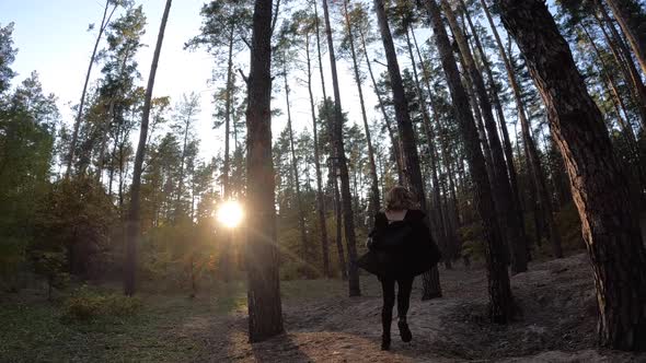 Running girl on a path in the woods