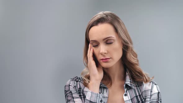 Upset Tired Young Casual Blonde Female Touching Head Thinking Worried About Problem Medium Close Up