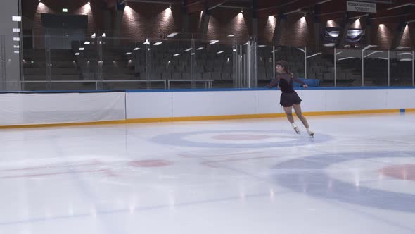 Teenage Girl Performing Ice Skating Routine