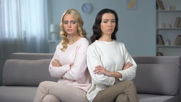 Two Angry Women Being in Quarrel Sitting on Sofa, Conflict Between Friends