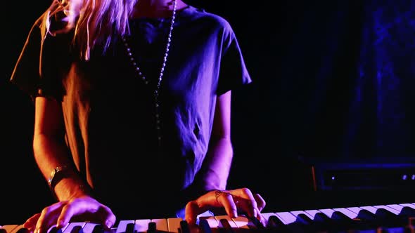 Woman playing electronic keyboard