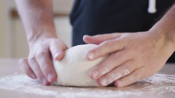Male Hands Preparing Dough on Table Closeup