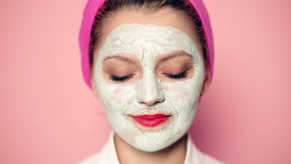 Close-up of a Funny Girl with a Mask on Her Face with a Wide-open Eyes Smiling. Girl with Cosmetic