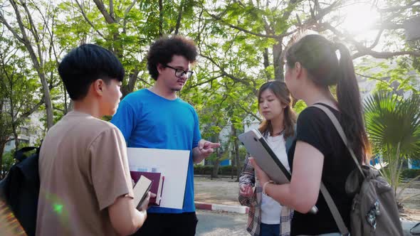 Asian student friends talking about study of class room. Education and student.