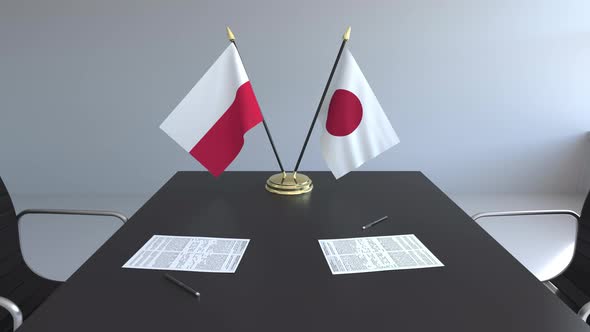 Flags of Poland and Japan on the Table alt