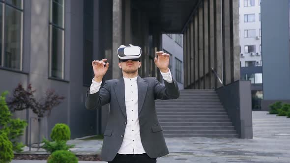 Smart Young Man in Special Protective 3d Glasses which Working on Virtual Screen Outdoors