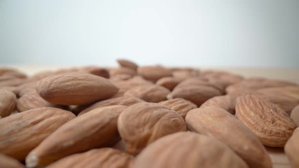 Slow Motion Drop and Almonds on the Table Closeup