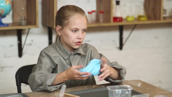 Laboratory Experience in a Chemistry Lesson,, a Girl Playing with a Blue Slime, Children's