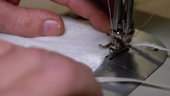 Tailor at Sewing Machine Sews a Homemade Medical Face Mask To Protect Covid-19