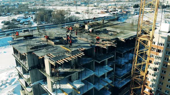 People Work on a Construction Site on High Building. Building Construction, Construction Industry alt