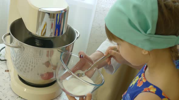 Mom Teaches Her Daughter How to Make Cream for a Cake Made of Egg Whites the Girl Adds Sugar to a