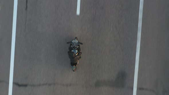 Top View to Biker Riding on Modern Sport Motorbike at Highway