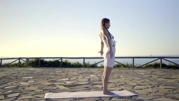 Slow motion shot of young woman doing yoga