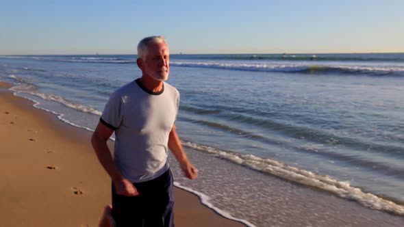 Senior Man Exercising At The  Beach