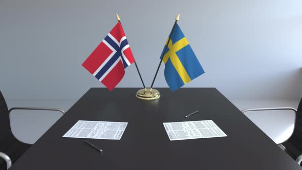 Flags of Norway and Sweden and Papers on the Table