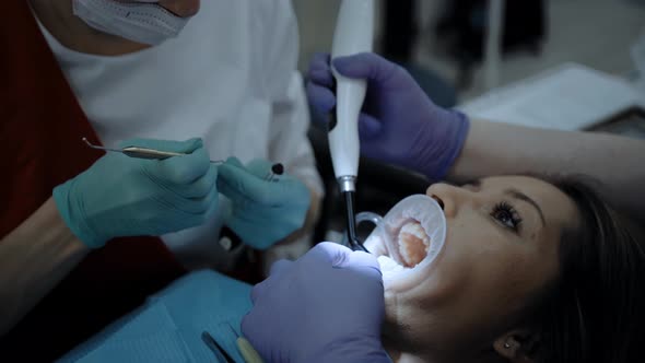 A Dentist at Work with Patient