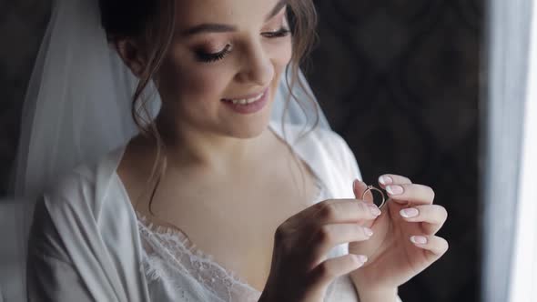Bride in Night Gown, Veil with Engagement Ring Near Window. Face Close Up Smiling. Wedding Morning