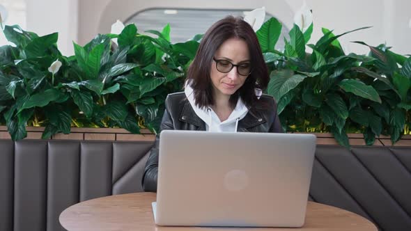 Young Professional Female Manager Using Laptop in Mall Businesswoman Working From Cafe Via Laptop