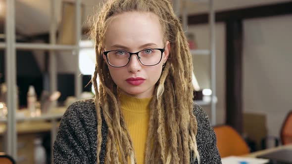 Stylish Woman with Dreadlocks Wears Glasses and Posing Into Camera