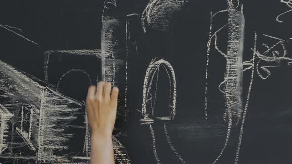 Hand of woman drawing on chalkboard