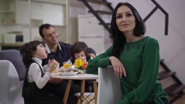 Portrait of Happy Beautiful Caucasian Woman Posing in Living Room with Cheerful Middle Eastern Man