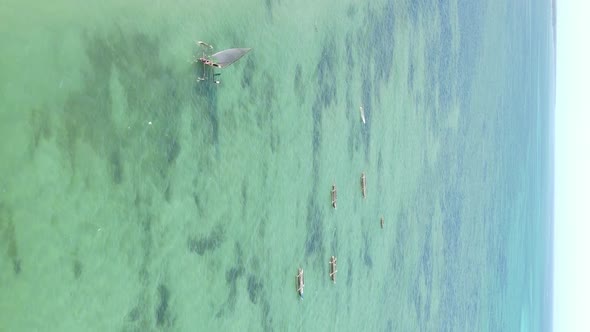 Vertical Video Boats in the Ocean Near the Coast of Zanzibar Tanzania Aerial View