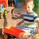 Footage of Little Boy Playing Una Snadbox with Plastic Toys - VideoHive Item for Sale