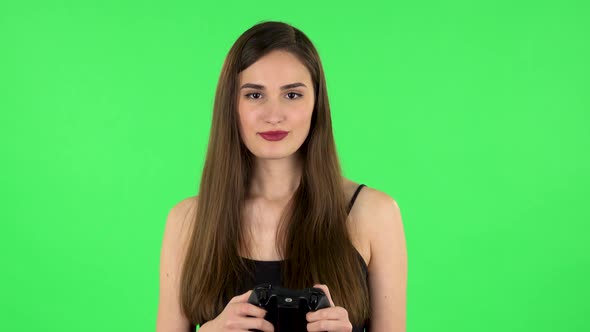 Girl Playing a Video Game Using a Wireless Controller with Joy and Rejoicing