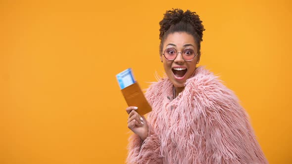 Happy Afro-American Woman Showing Passport With Tickets, Vacation Tour, Low-Cost