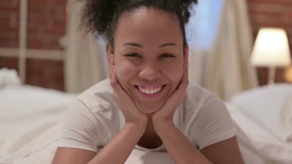 Portrait of African Woman Smiling at the Camera in Bedroom