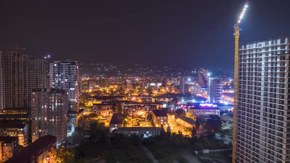 Night Construction Site in a Big City Metropolis with Skyscrapers and Buildings. Timelapse.