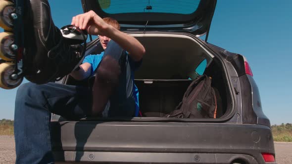 Young Man Puts On Roller Skates