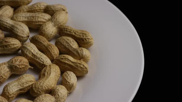 Cinematic, rotating shot of peanuts on a white surface - PEANUTS 008