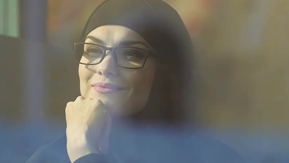 Happy Muslim Woman in Glasses Looking Through Window, Success in Career and Life