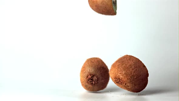 Super Slow Motion Kiwi Halves Fall on the Table