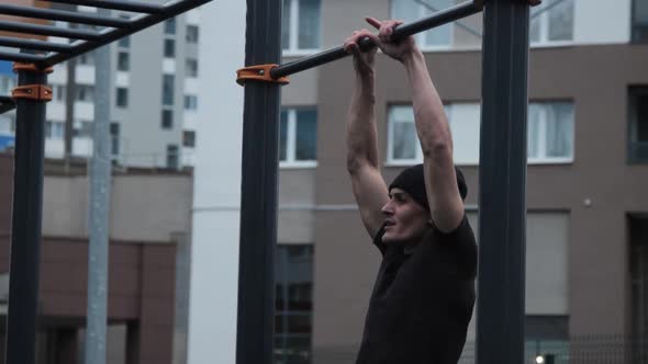 Muscular man training outdoors on sports field