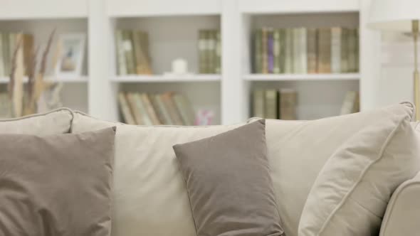 Young African Woman Coming and Sitting on Sofa