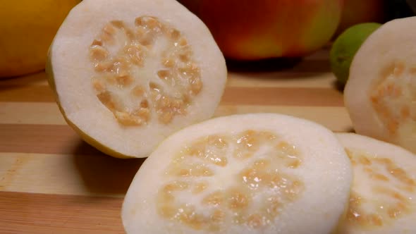 Guava Cut Into Slices Lies on a Bamboo Board