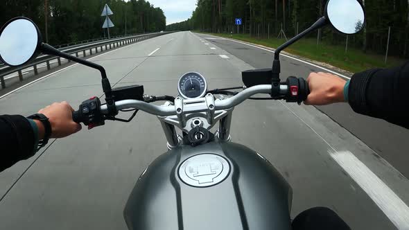 First Person View of Driving on a Motorbike at the Highway Through the Forest