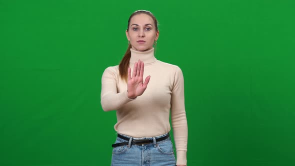 Young Woman Stretching Hand at Camera Showing Stop Gesture and Shaking Head No