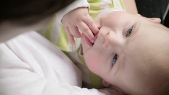 Mother Breastfeeding Child at Home