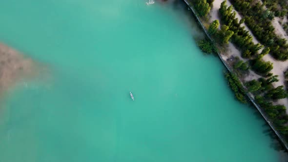 Man Ride on SUP Board in the Mountain Lake