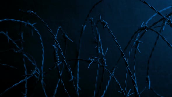 Passing Barbed Wire By Wall At Night