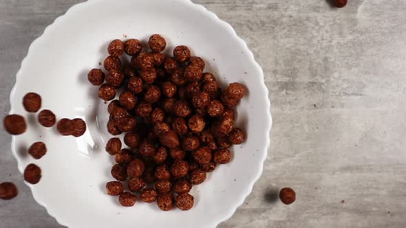 Cooking Tasty Meal Consisting of Chocolate Cornflakes in Form of Balls in Slow Motion