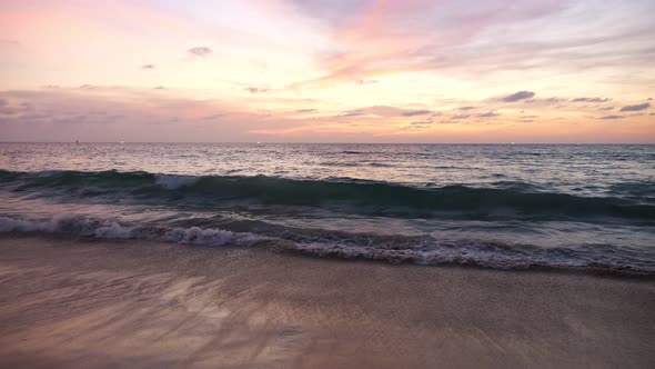 Ocean Waves Roll on Empty Sandy Beach Under Beautiful Sky