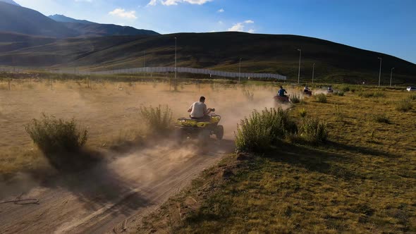 Aerial View From Behind ATVs by Lake and Mountain