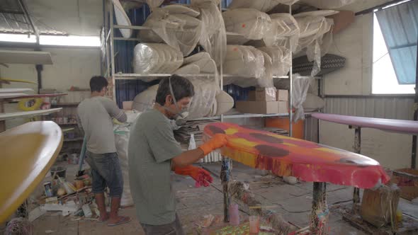 Two Indonesian Craftsmen Making Surfboards Together