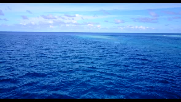 Aerial flying over travel of marine seashore beach vacation by clear ocean and white sandy backgroun