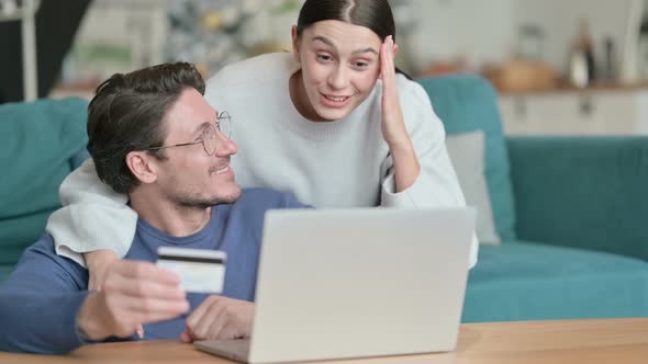 Hispanic Couple Making Online Shopping Payment on Laptop