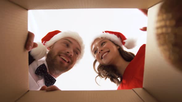 Happy Couple Opening Box with Christmas Tree Toys